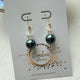 Gold filled oorbellen met Swarovski parel in blauw zwart