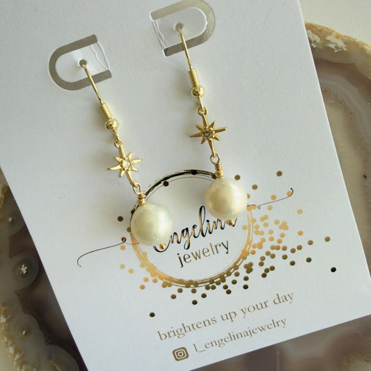 Gold filled oorbellen van zoetwaterparels aan gold filled ster